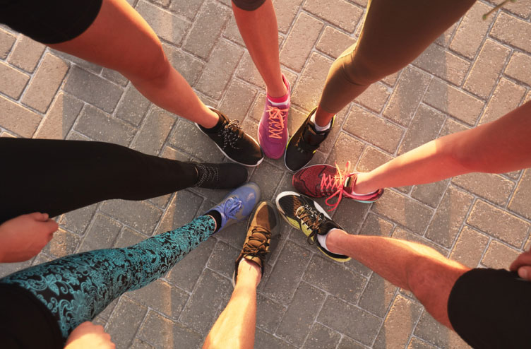 fitness people putting their feet together